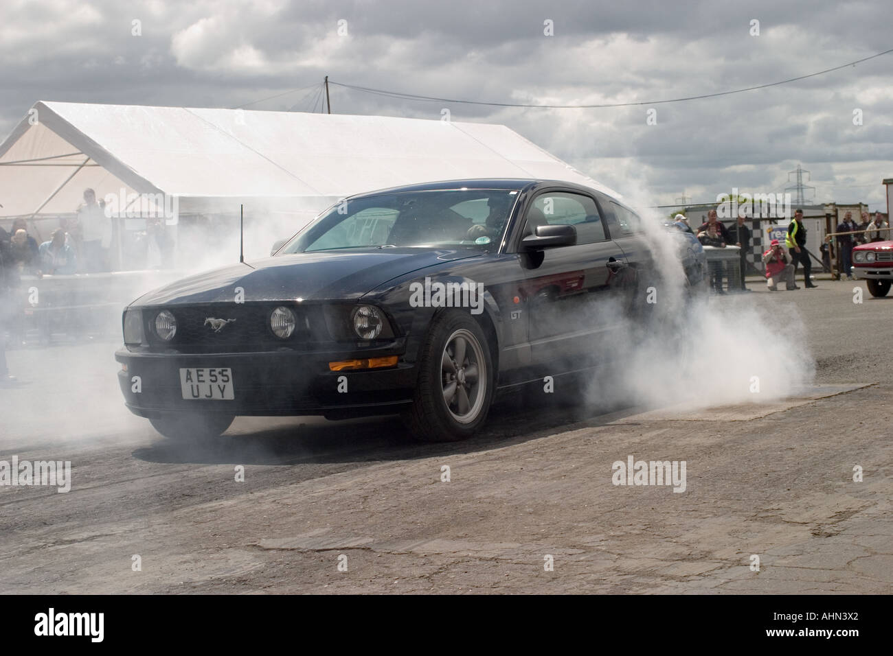 Late model Ford Mustang doing burnout at Melbourne Raceway North Yorkshire England Stock Photo