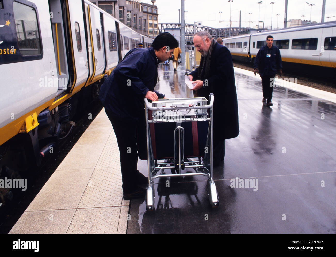 Gare du Nord Paris train station. Eurostar passenger and staff loading luggage on station platform. Channel crossing France to London, England Stock Photo