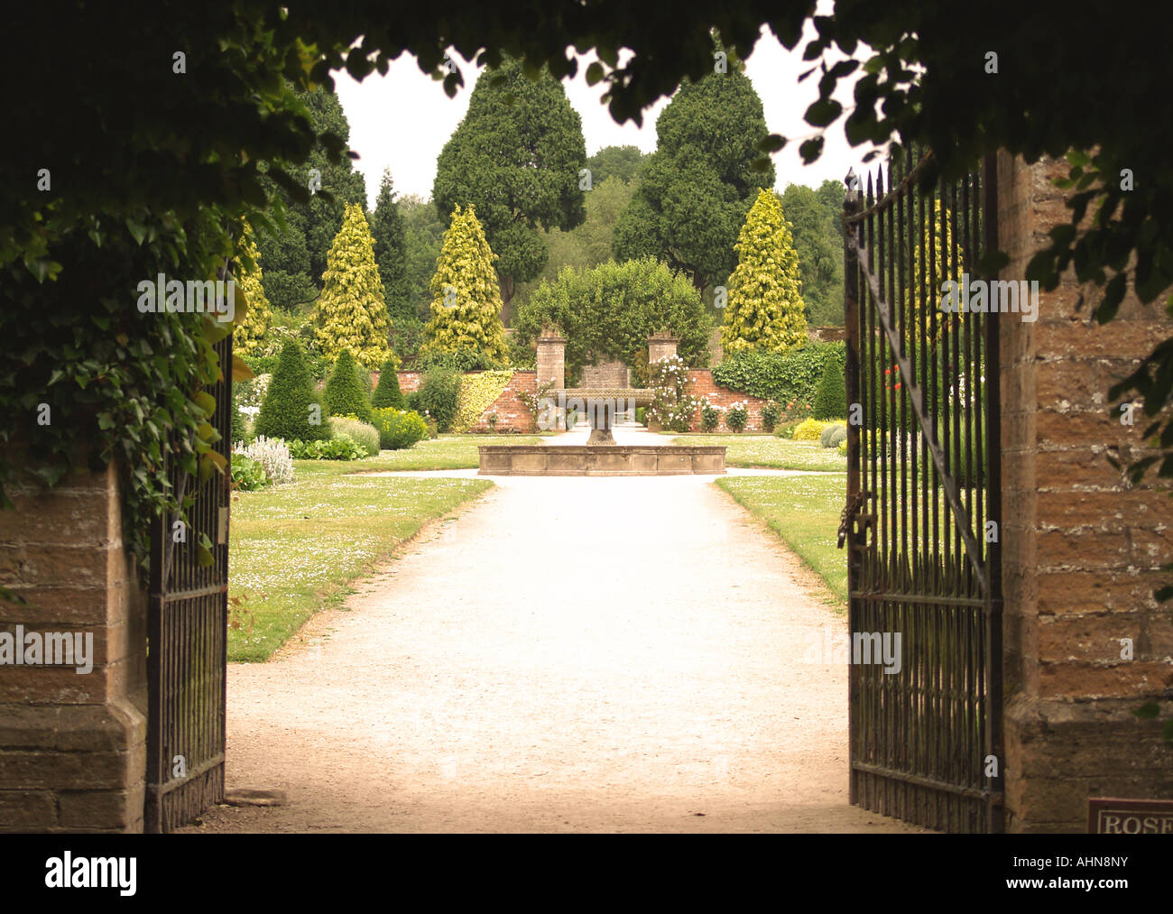 Looking through iron gates into the Rose Garden at Newstead Abbey, Nottinghamshire UK Stock