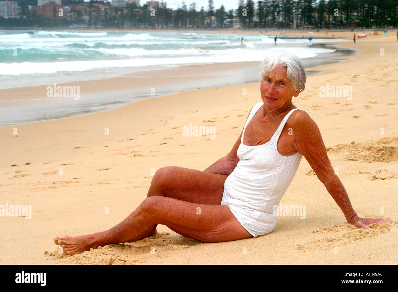An old beach sunbather at Manly beach Sydney Australia Stock Photo