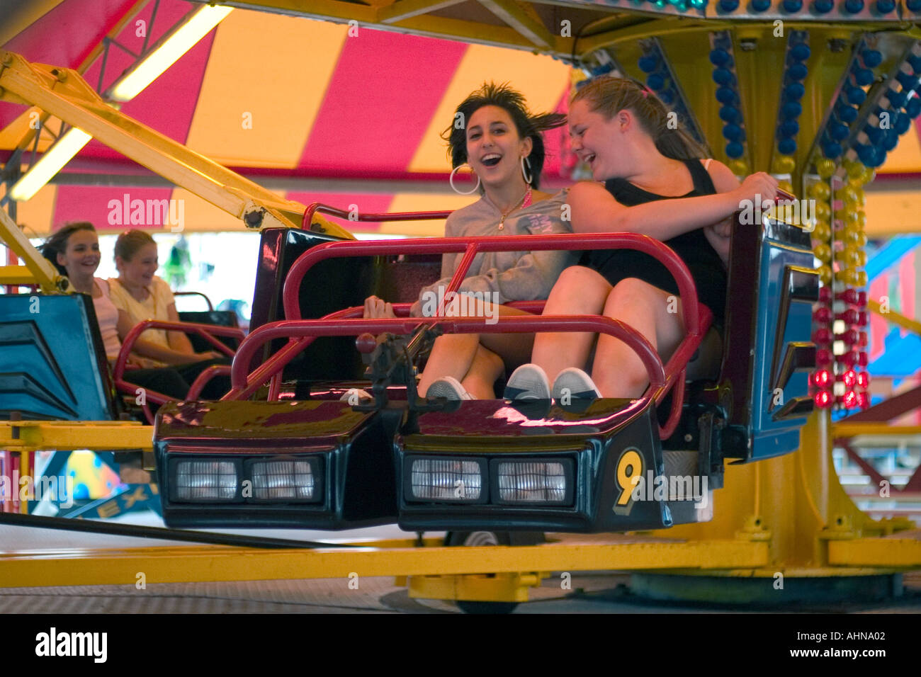 Girls on funfair ride on East Pier. Brighton, England Stock Photo