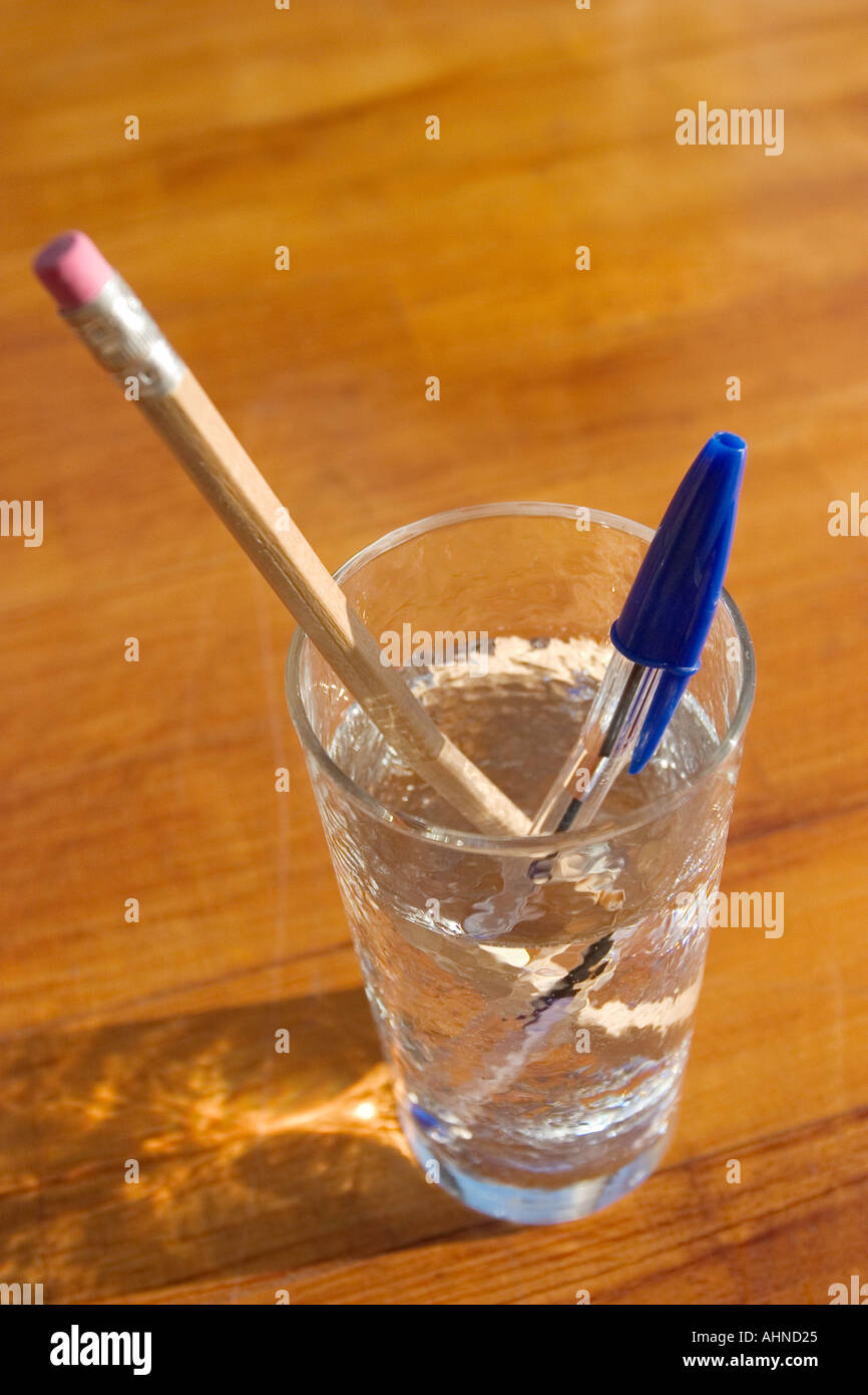fluorescent pen and crayon in a full water glass stock photo