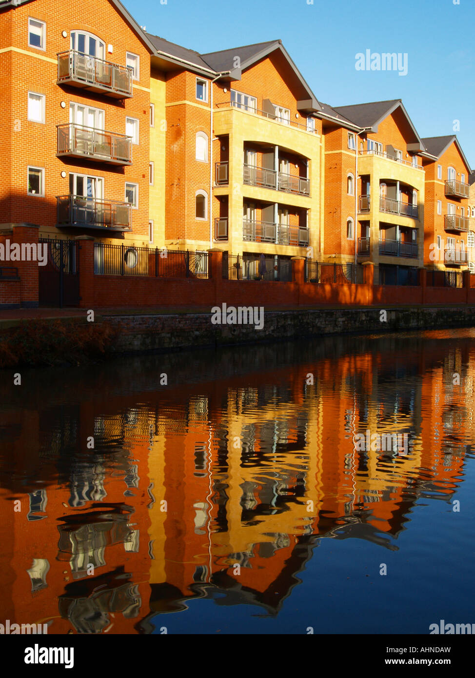 Modern apartment buildings reflected in the canal, on the waterfront in
