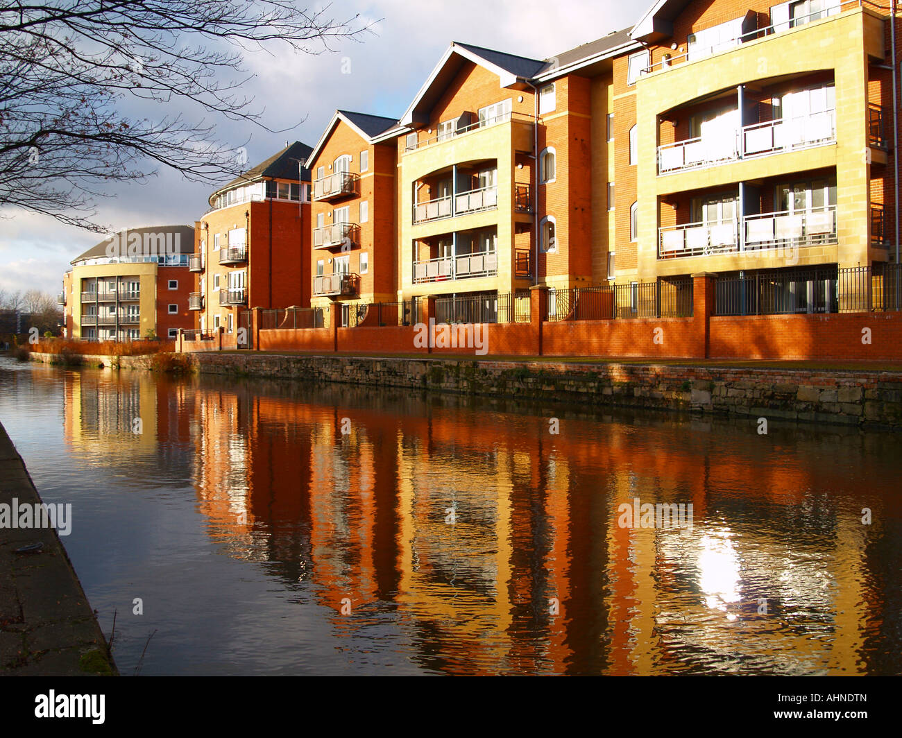 Modern apartment buildings reflected in the canal, on the waterfront in
