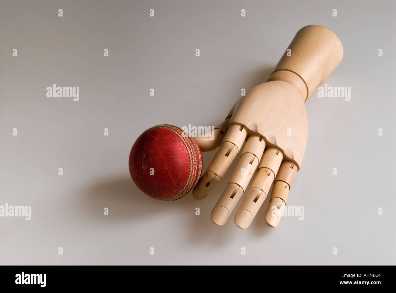 cricket ball and wooden hand Stock Photo