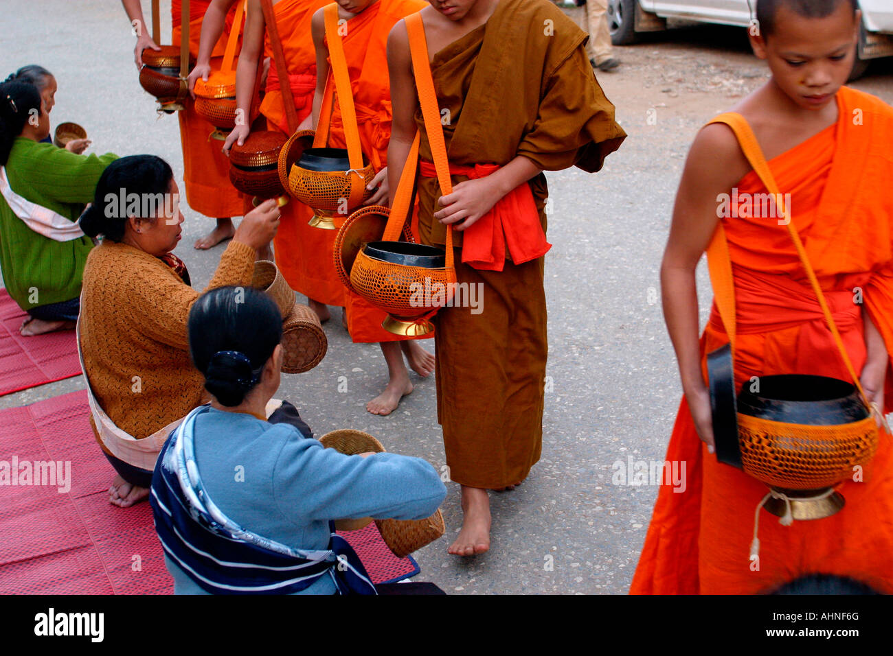 Laos Luang Prabang Religion saffron robed monks on morning alms round ...