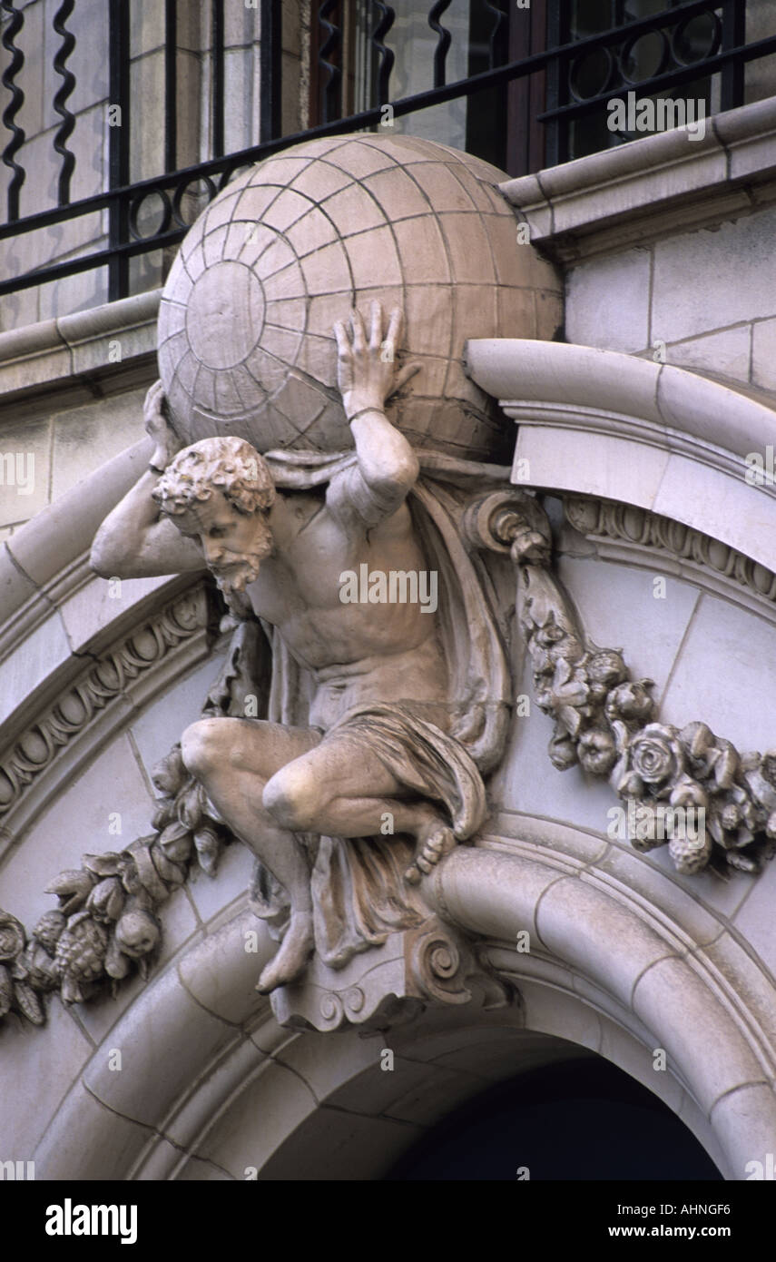 stone carving of atlas carrying the weight of the world on his shoulders on banking building in leeds uk Stock Photo