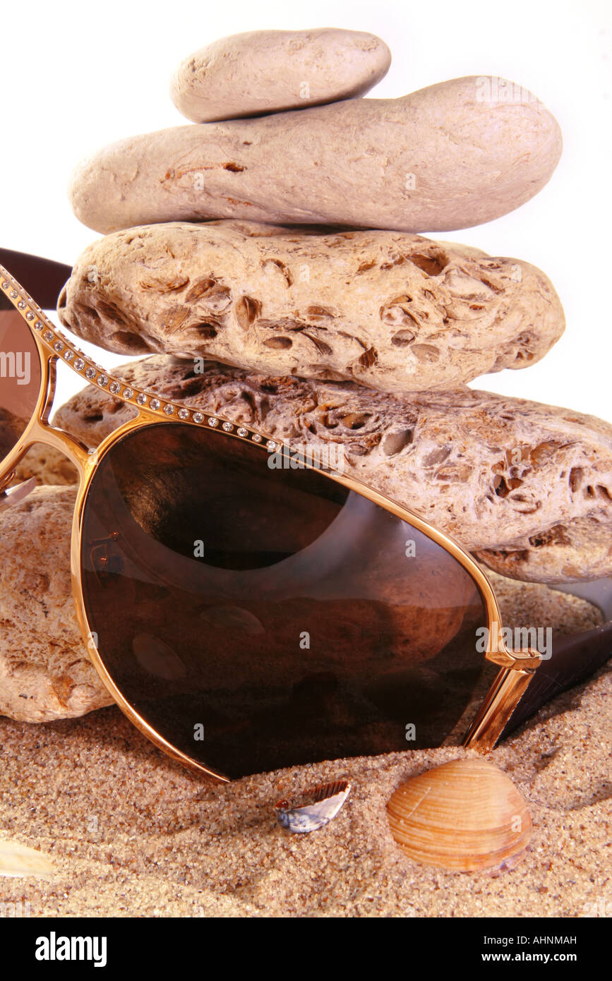 Sun glass on sand abckground with seashell Stock Photo