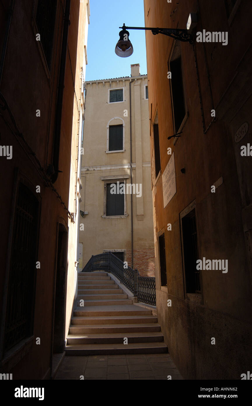 Narrow empty street and bridge in Castello district Venice Italy Stock Photo