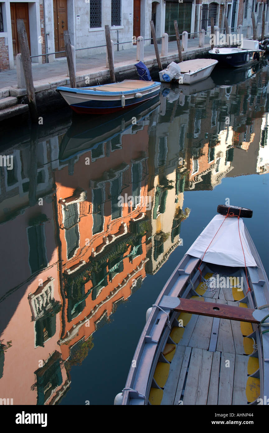 Reflection of architecture in canal with boat Venice Italy Stock Photo ...