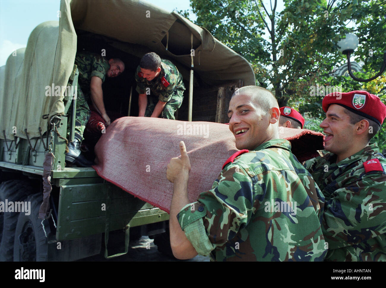 Bulgarian army recruits loading a red carpet on a truck after a festivity in Sofia, Bulgaria Stock Photo