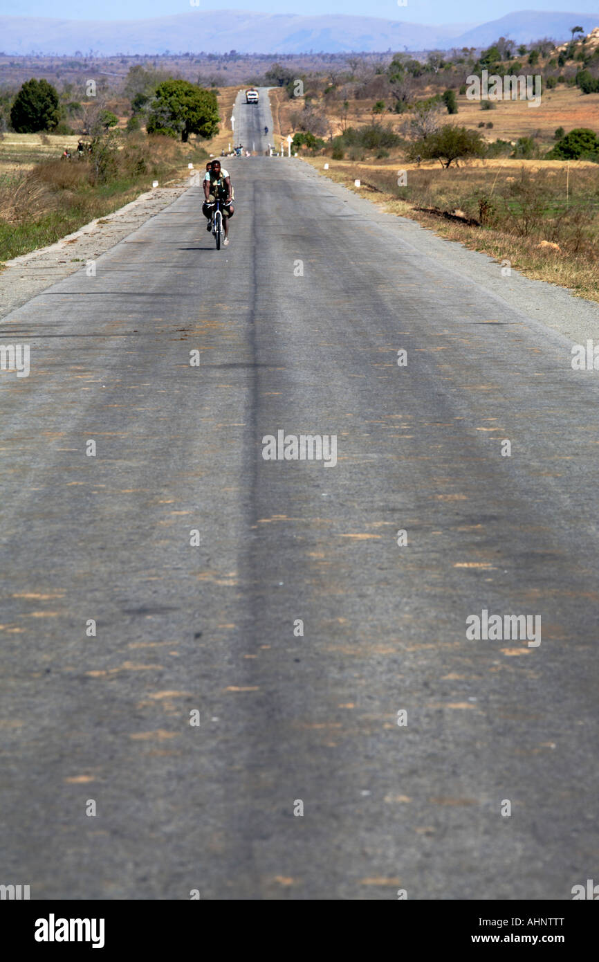 Cyclist on a countryside Road, Madagascar Stock Photo
