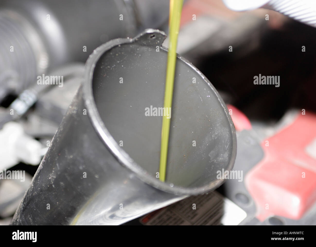 Oil being poured into funnel oil change Stock Photo Alamy