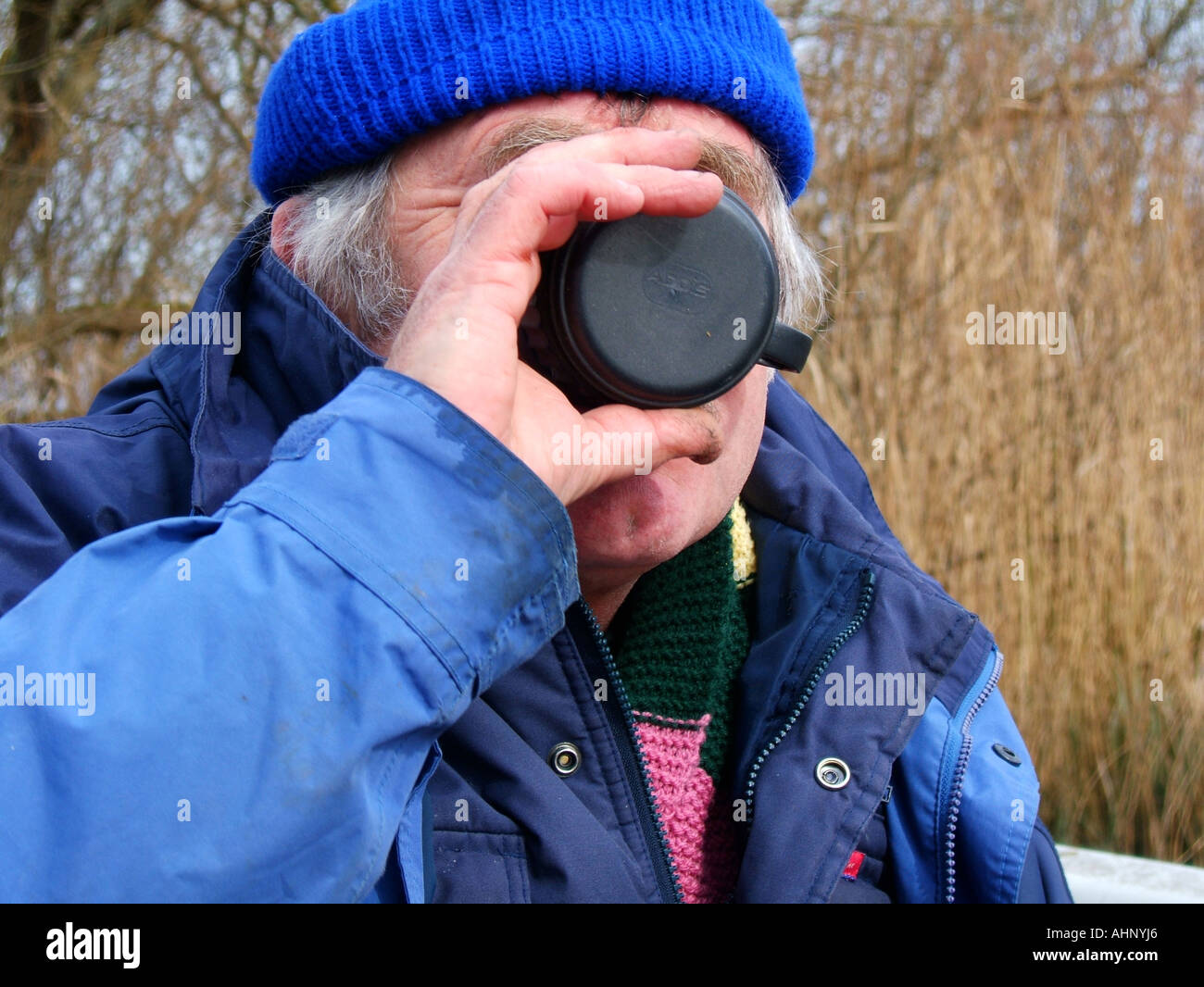 man drinking from thermos flask cup Stock Photo Alamy