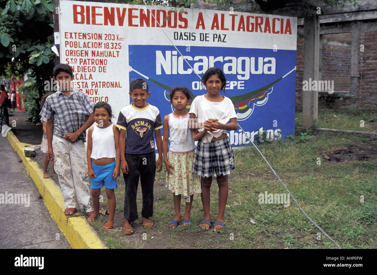 Nicaraguan children standing next to welcome sign at the entrance to the town of  Altagracia, Isla de Ometepe or Ometepe Island, Nicaragua Stock Photo