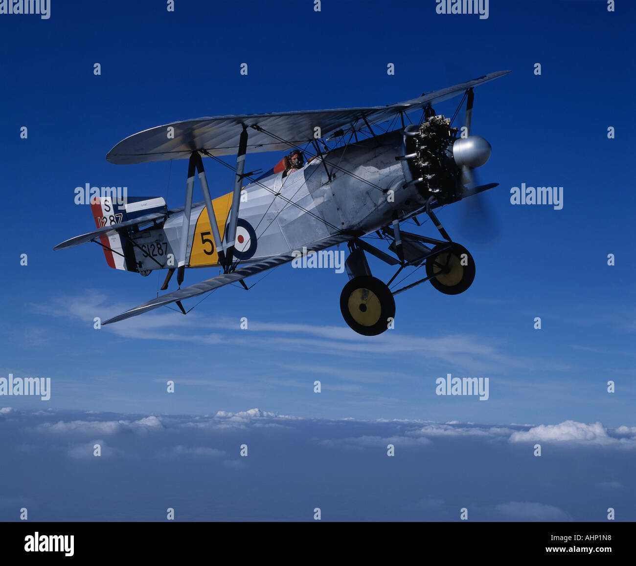 Fairey Flycatcher vintage bi-plane above clouds Stock Photo