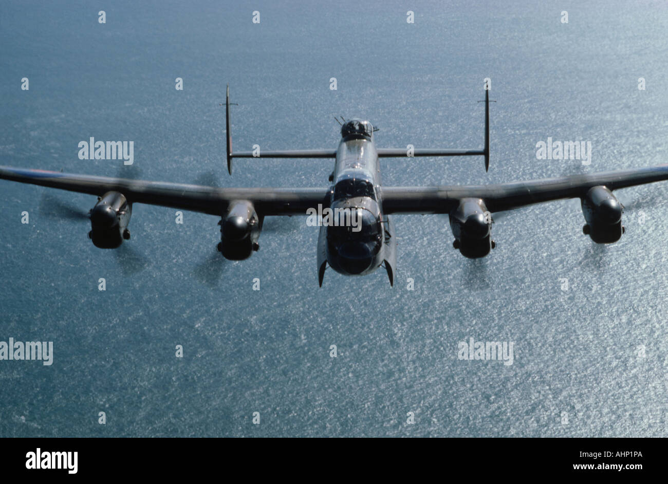 Avro 683 Lancaster bomber over sea Stock Photo