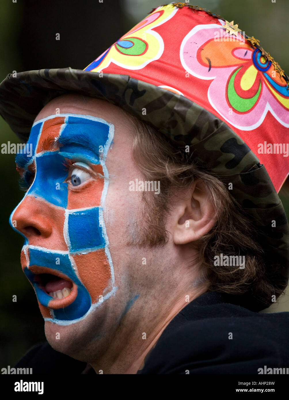 Entertainer with chequered face paint at the Edinburgh festival fringe