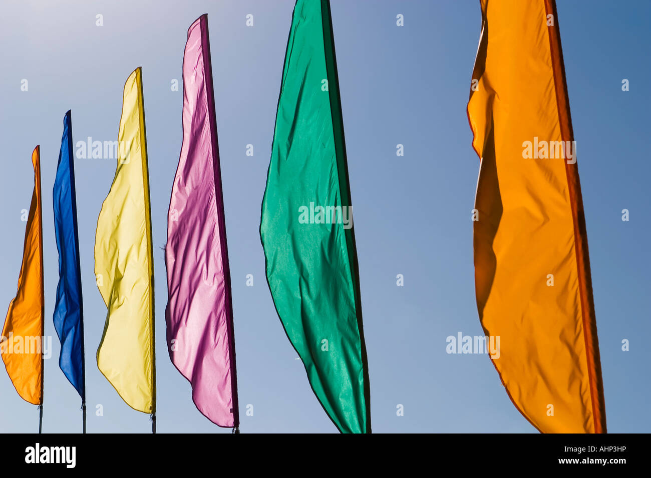 Brightly colored banners waving in the wind. Stock Photo