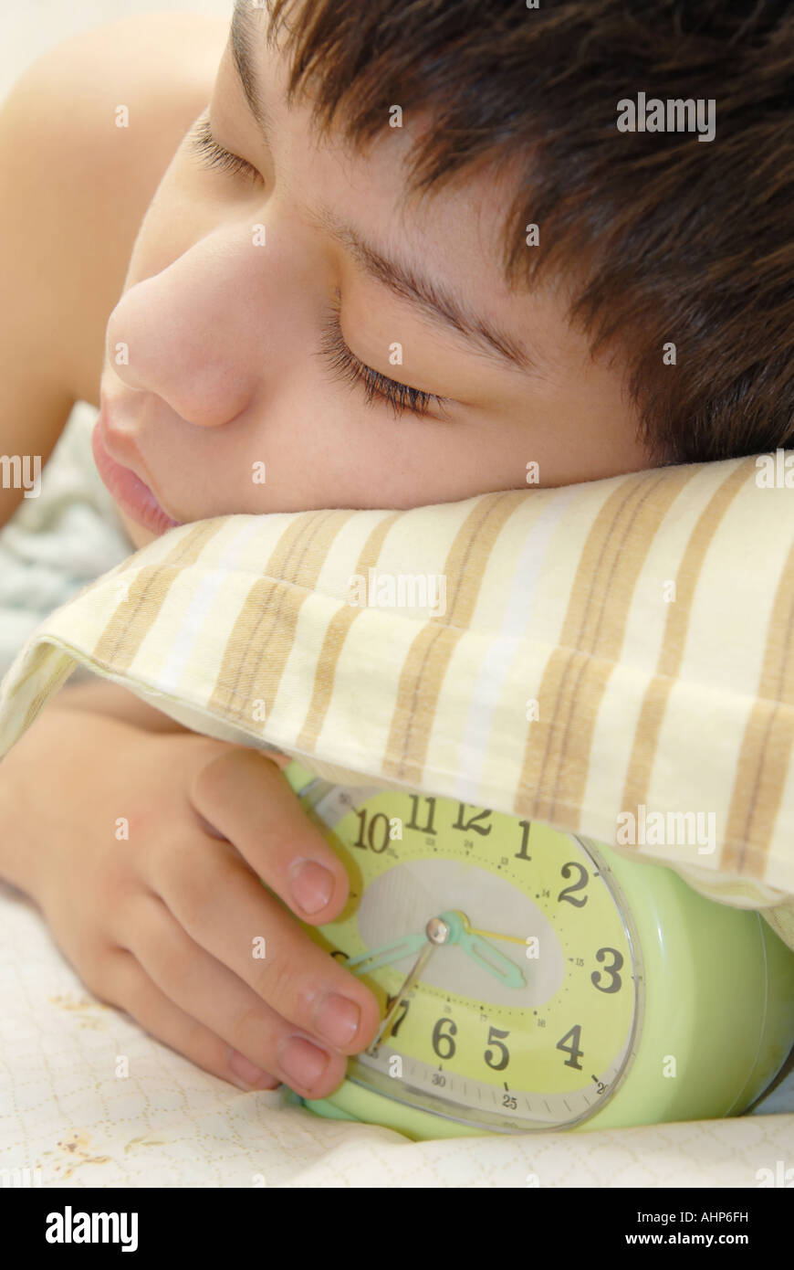 Deep sleeping boy and alarm clock Stock Photo Alamy