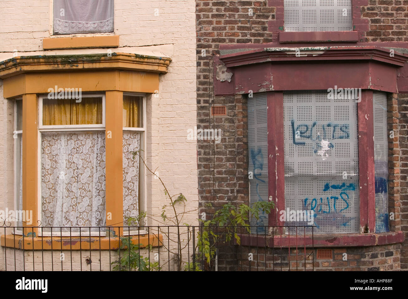 Boarded up house next to a lived in house in kensington Liverpool Stock Photo