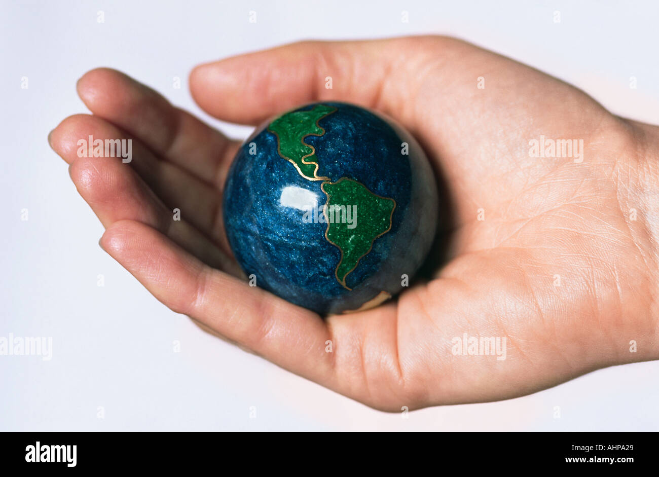 Cloisonne Globe in Hand with Light coloured Background Stock Photo