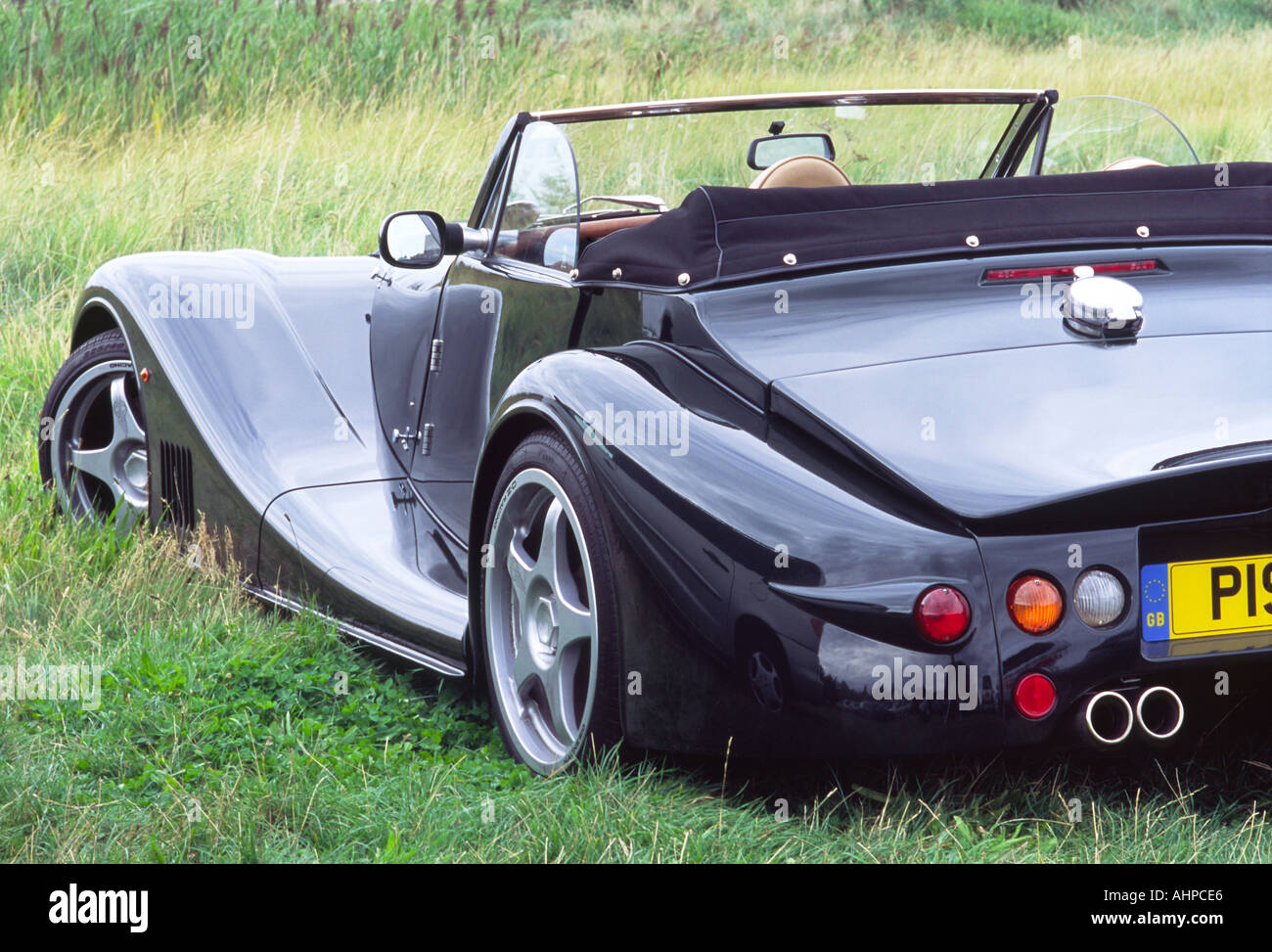 Black Morgan Aero 8 Parked on Grass by Reed Bed Stock Photo