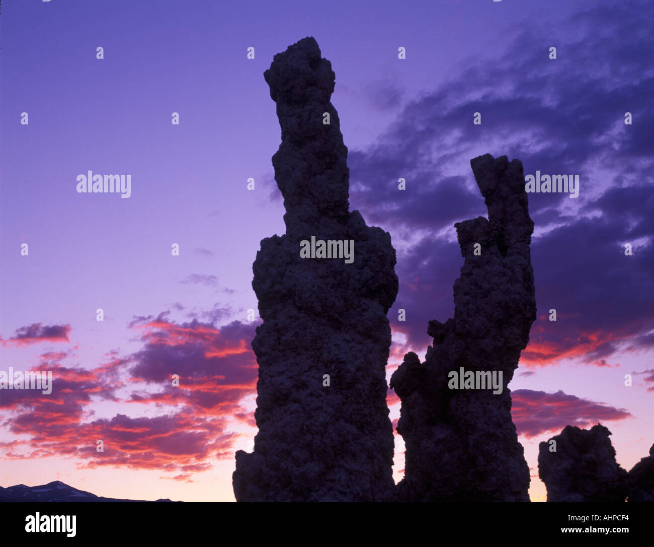 Silhouetted tufa and sunset clouds Mono Lake California Stock Photo