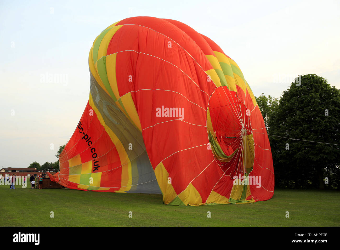 A hot air balloon deflating after landing in a field in Cheshire Stock
