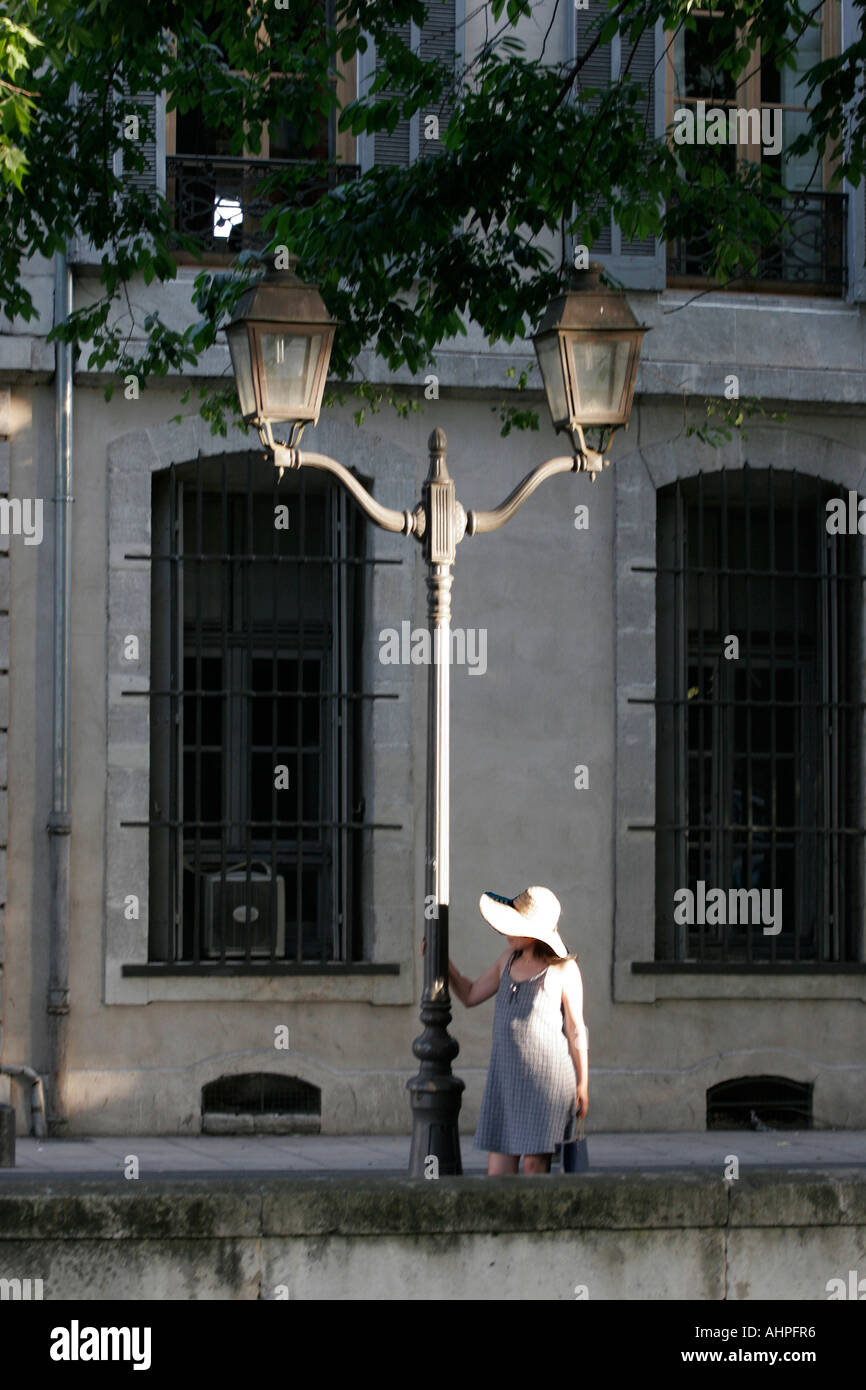 Girl waiting by a lampstand in a French street: series 4 of 5 Stock Photo