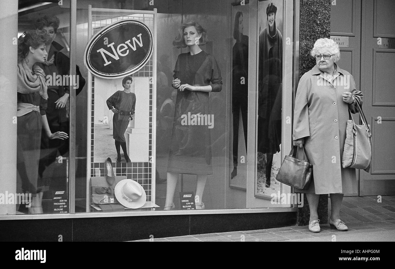 Old lady shopping standing in front of clothes shop Stock Photo - Alamy