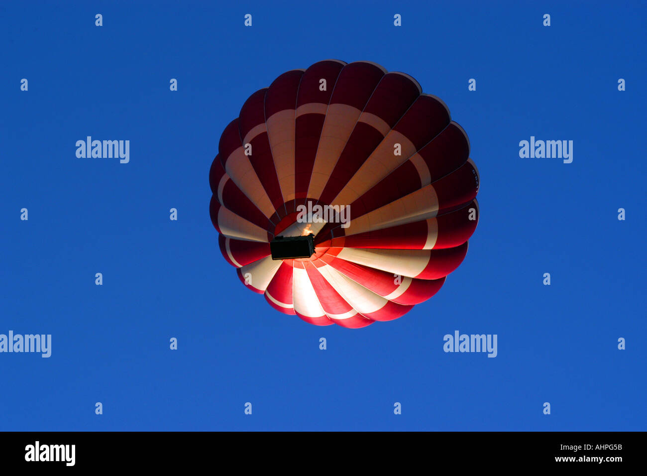 A Red and White Hot air balloon against a blue sky background Stock ...