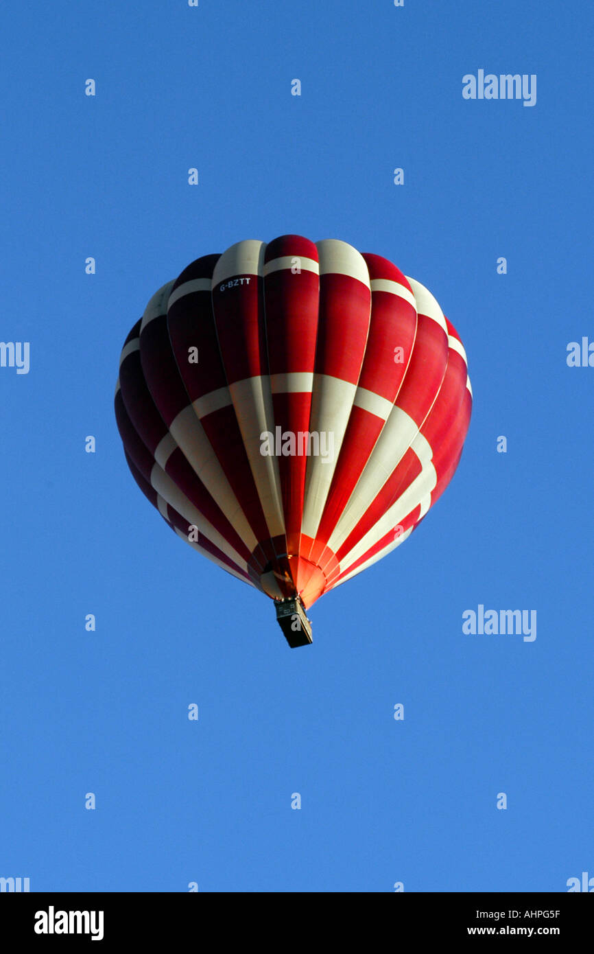 A Red and White Hot air balloon against a blue sky background Stock ...