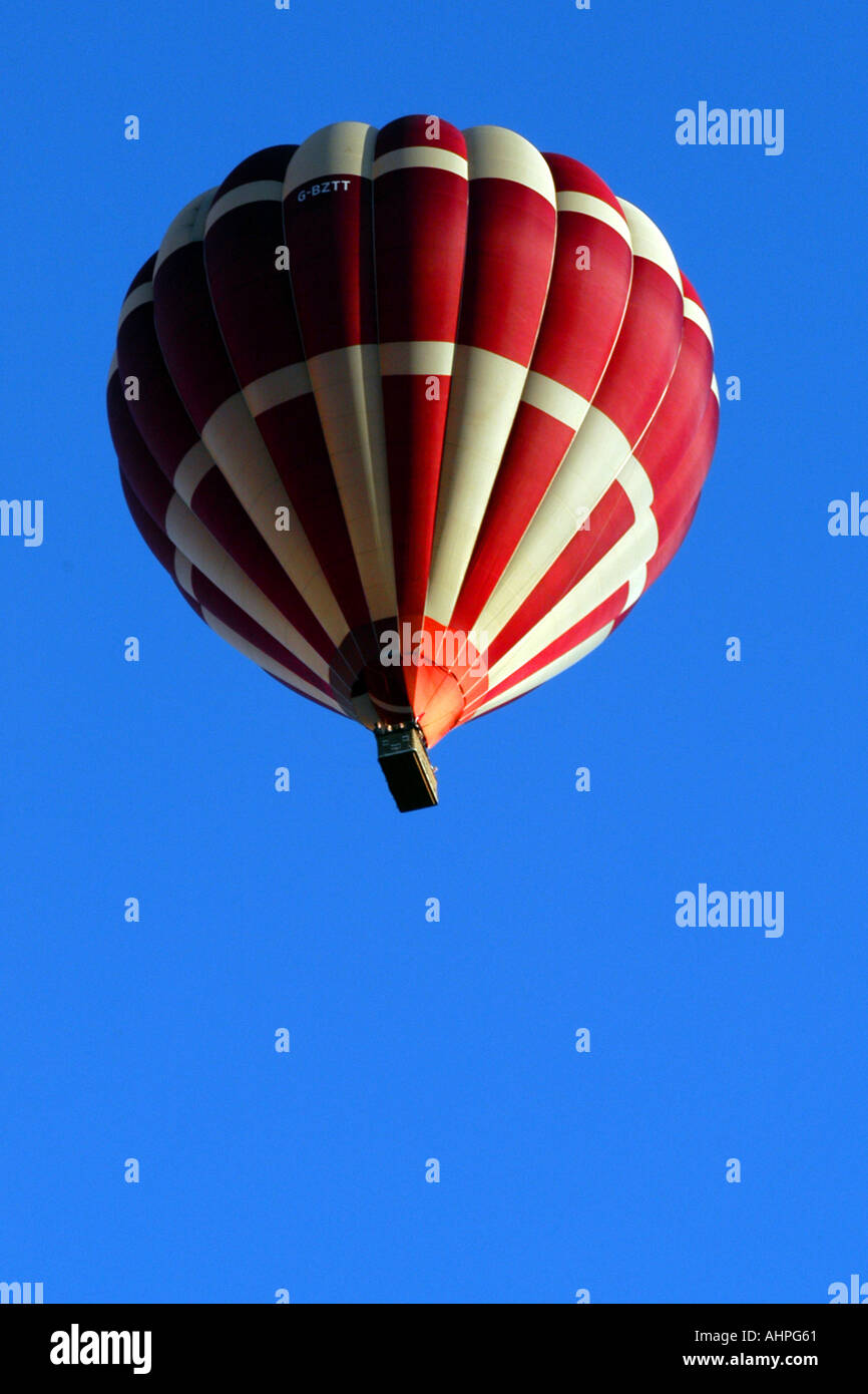 A Red and White Hot air balloon against a blue sky background Stock ...