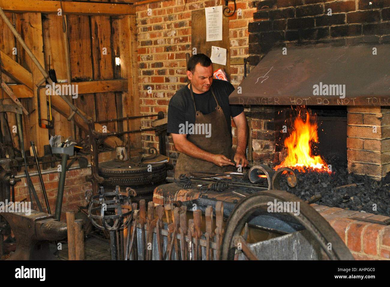 A Blacksmith at work in his forge creating a set of Wrought Iron gates ...