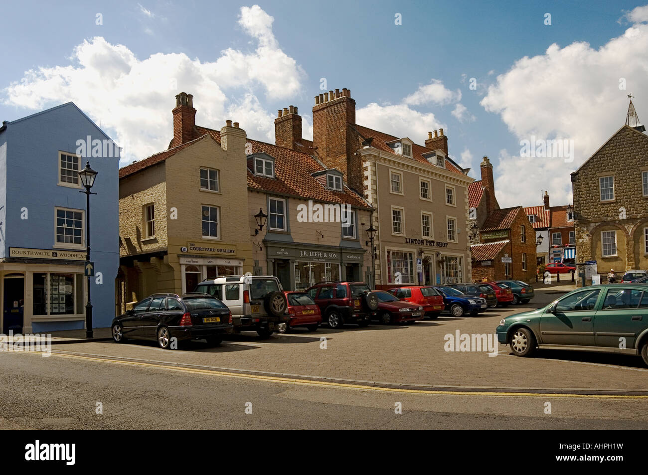 Shops stores in summer Market Place Malton North Yorkshire England UK