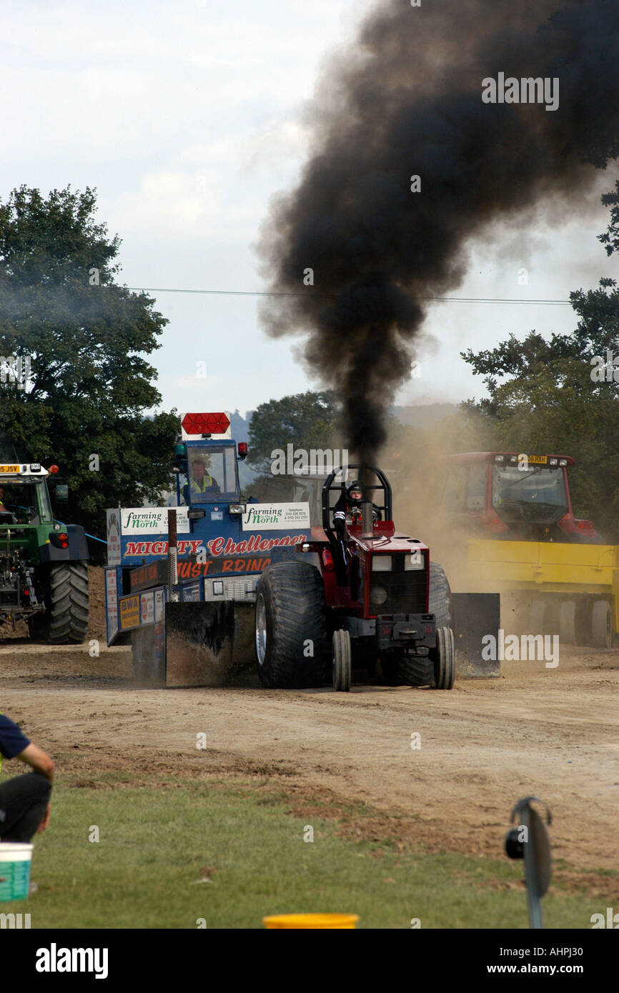 A Tractor pulling event with lots of black smoke polluting the atmosphere. Stock Photo