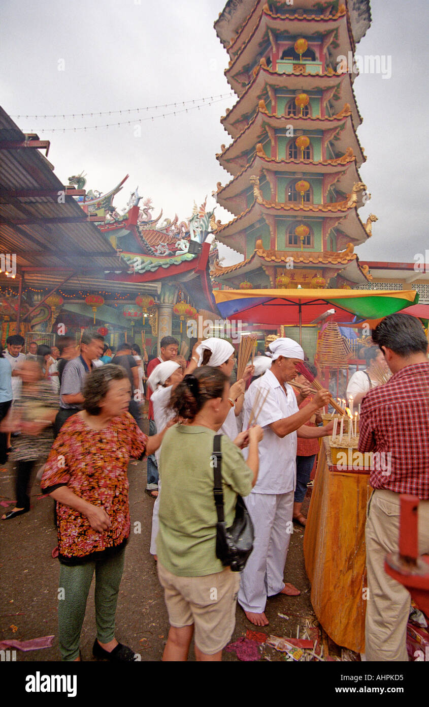 Men and women praying outside a Chinese temple in Kuala Lumpur Malaysia during the Nine Emperor Gods Festival Stock Photo