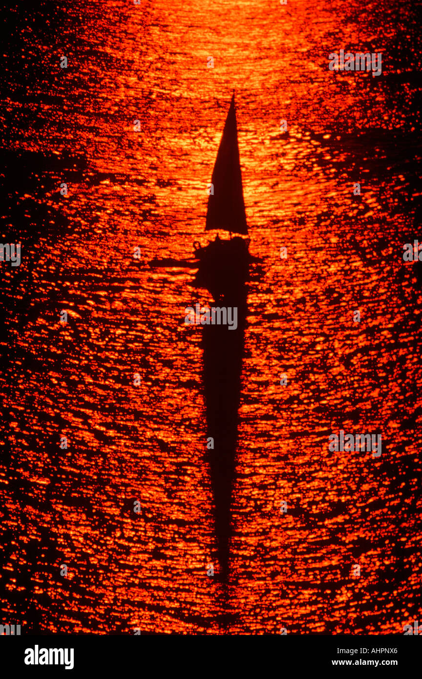 Aerial view of silhouetted sailboat at sunset Stock Photo - Alamy