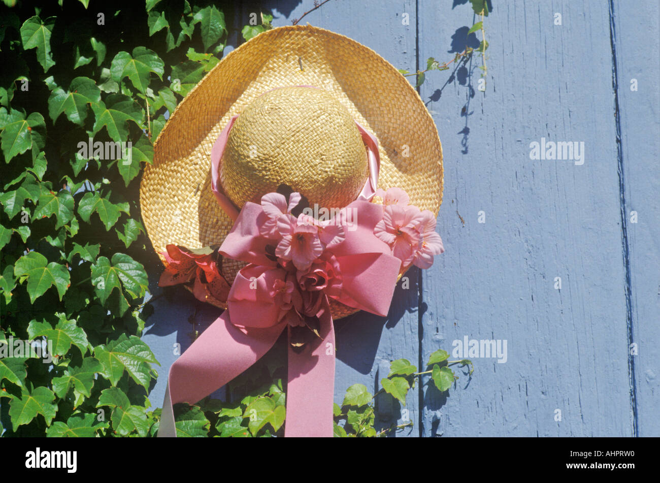 Decorated straw hat nailed onto a door Stock Photo