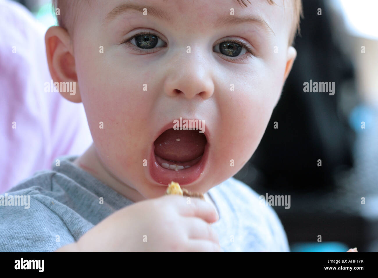 A one year old boy eating Stock Photo - Alamy