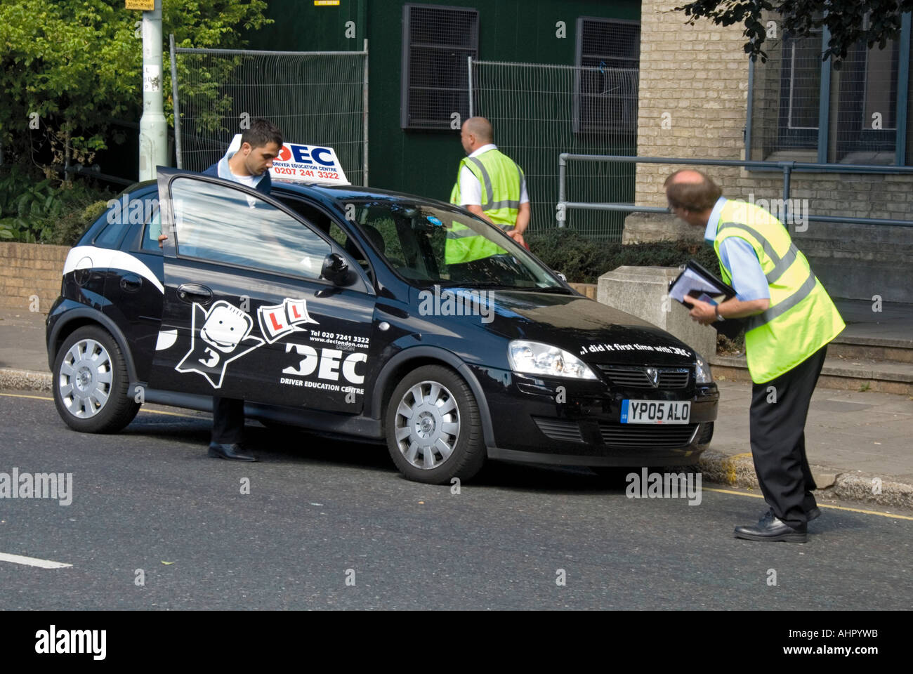 Driving Test Examiner Assessing Vehicle Before Testing Learner Driver driving-test-examiner-assessing-vehicle-before-testing-learner-driver