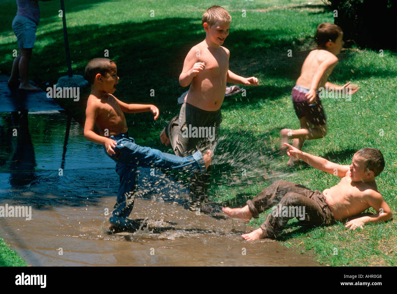 Boys playing in water San Bernardino California Stock Photo