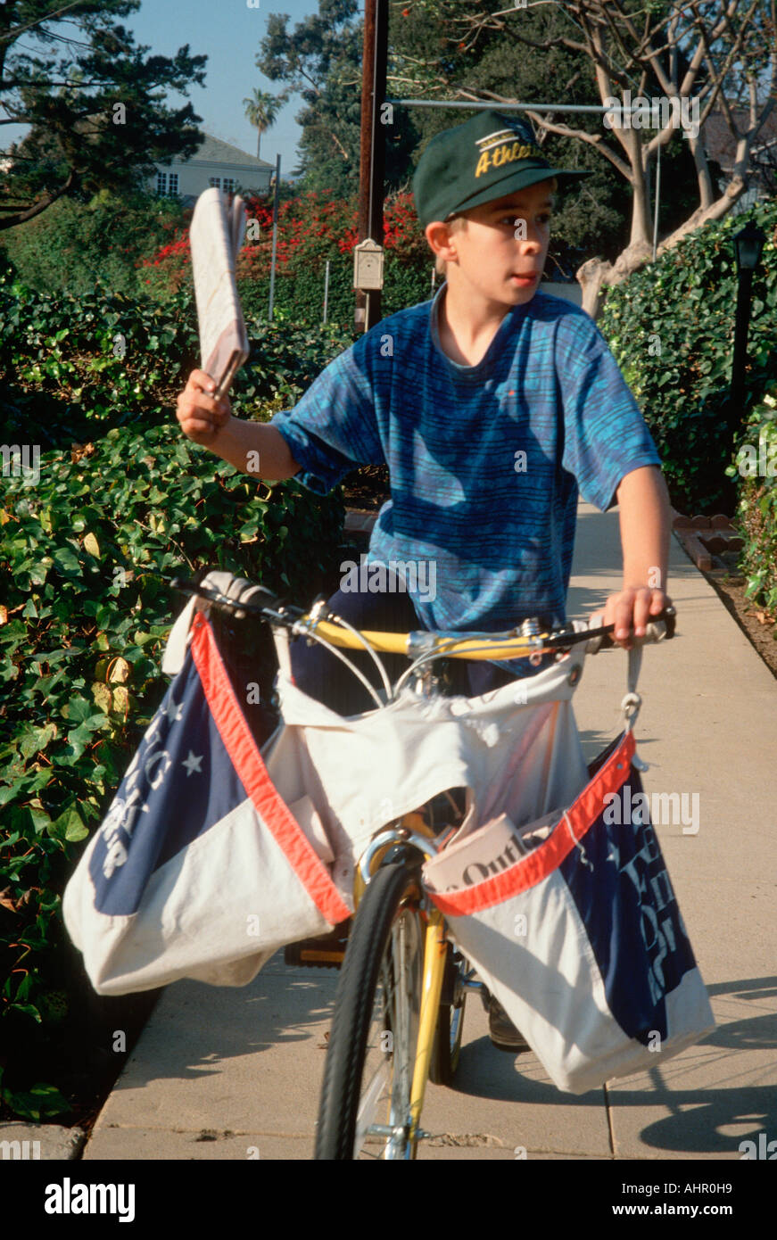 Newspaper delivery boy on bicycle Los Angeles California Stock Photo