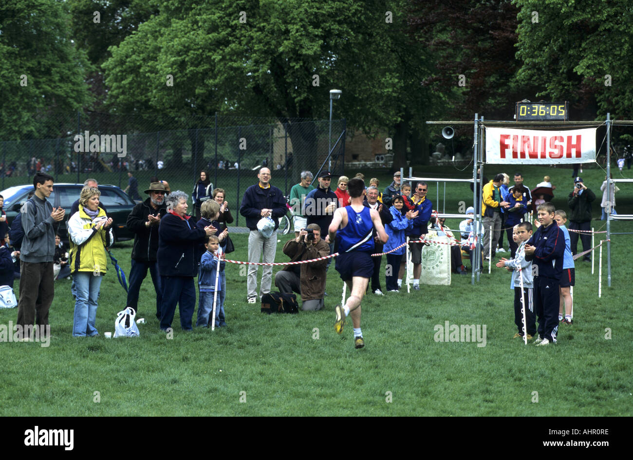 People applauding finisher in Hilly Challenge race, Abbey Fields, Kenilworth, Warwickshire, England, UK Stock Photo