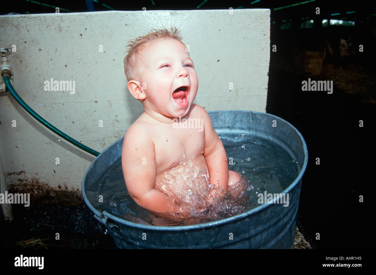 Baby sitting in galvanized bath tub Stock Photo Alamy