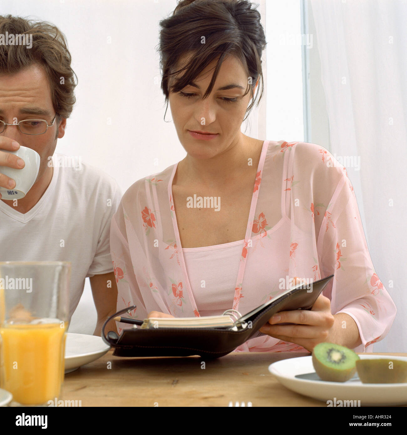 Couple with diary at breakfast Stock Photo