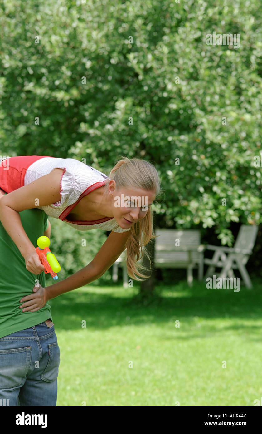 Young woman water pistol hi-res stock photography and images - Alamy