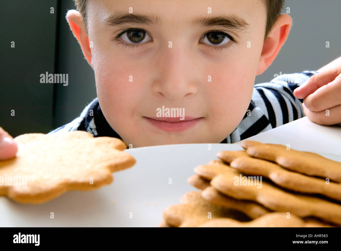 Boy holding a biscuit Stock Photo Alamy