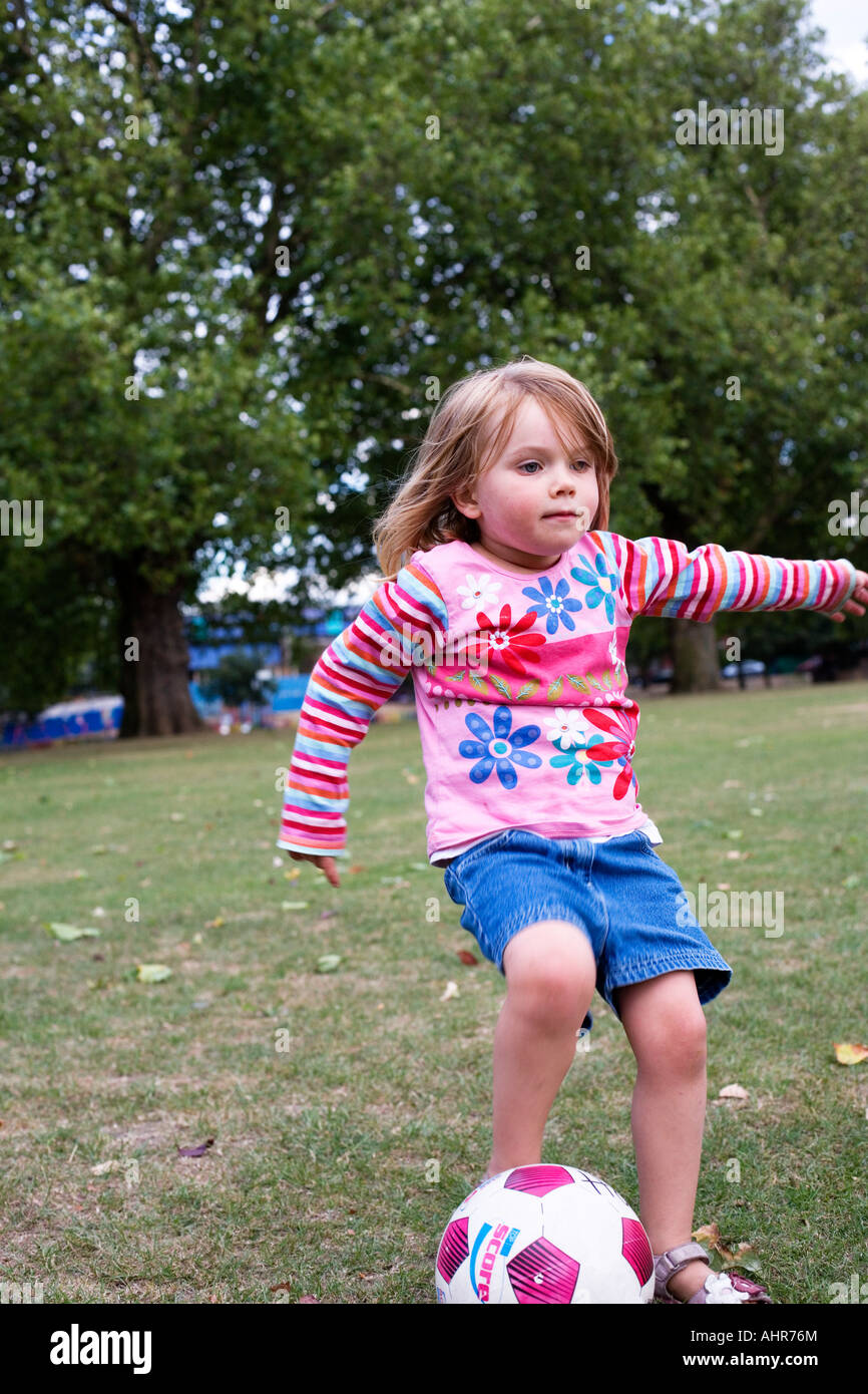 girl playing football in the park Stock Photo - Alamy